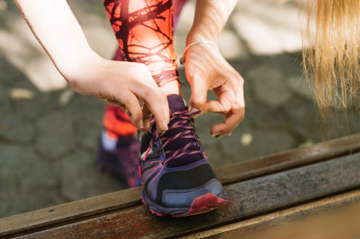 Crop Woman Tying Laces Sneakers